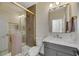 Modern bathroom with gray vanity and gold fixtures at 1343 Panini Dr, Henderson, NV 89052