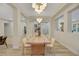 Elegant dining room showcasing a long wooden table and modern lighting at 1343 Panini Dr, Henderson, NV 89052