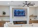 Modern living room featuring a built-in fireplace and large TV at 1343 Panini Dr, Henderson, NV 89052