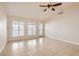 Bright living room with tile flooring, ceiling fan, and access to patio at 4812 Winterset Dr, Las Vegas, NV 89130