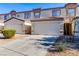 Front view of a two-story townhome with a two-car garage at 5330 E Charleston Blvd # 101, Las Vegas, NV 89142