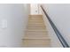 Modern staircase with light wood steps and dark handrail at 5376 Modena Dr, Las Vegas, NV 89120