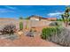 Landscaped backyard with cacti, rocks, and a block wall at 5865 N Conquistador St, Las Vegas, NV 89149