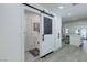 Convenient laundry area features modern storage and a barn door at 8901 Dio Guardi Dr, Las Vegas, NV 89117