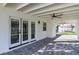 Covered patio with paver stones, double French doors, and ceiling fans at 8901 Dio Guardi Dr, Las Vegas, NV 89117