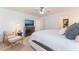 Bright bedroom featuring a king-size bed, a TV, and a cozy armchair at 9132 Pearl Cotton Ave, Las Vegas, NV 89149