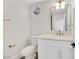 Modern powder room with white vanity and gold fixtures at 9901 Laurel Springs Ave, Las Vegas, NV 89134