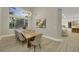 Elegant dining room with a large live-edge table and modern chandelier at 9901 Laurel Springs Ave, Las Vegas, NV 89134