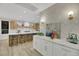 Modern kitchen with island, marble countertops, and wood cabinets at 9901 Laurel Springs Ave, Las Vegas, NV 89134