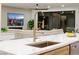 Modern kitchen island with gold faucet and stainless steel sink at 9901 Laurel Springs Ave, Las Vegas, NV 89134