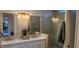 Elegant bathroom with double vanity and large mirrors at 10612 Back Plains Dr, Las Vegas, NV 89134