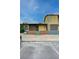 Tan and brown exterior of a single story home with a green fence at 155 E Van Wagenen St, Henderson, NV 89015