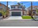 Two story house with gray garage door and landscaped lawn at 1725 Rugged Ravine Ct, Las Vegas, NV 89183