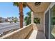 Private balcony with tiled flooring and views of palm trees and street at 1747 Jupiter Ct # D, Las Vegas, NV 89119