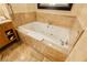 Soaking tub with jets and stone tile surround at 2000 Fashion Show Dr # 5319, Las Vegas, NV 89109