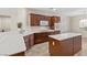 Spacious kitchen with dark wood cabinets, white countertops, and an island at 2285 Rosendale Village Ave, Henderson, NV 89052