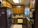 L-shaped kitchen with wood cabinets and appliances at 2425 Paradise Village Way, Las Vegas, NV 89120