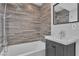 Modern bathroom with wood-look tile and bathtub at 3777 Garden North Dr, Las Vegas, NV 89121