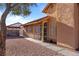 Side view of a tan house with a walkway and gravel at 3973 El Camino Rd, Las Vegas, NV 89103