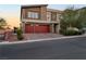 Modern two-story house with red double garage doors at 6407 Carmel Creek Ave, Las Vegas, NV 89139