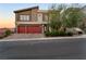 Two-story home with red garage doors and landscaped yard at 6407 Carmel Creek Ave, Las Vegas, NV 89139