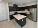 Modern kitchen with dark cabinets and quartz countertops at 654 Bellus Pl # Lot 185, Henderson, NV 89015