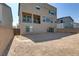 Spacious backyard with gravel and a two-story home at 7180 Grace Estate Ave, Las Vegas, NV 89113