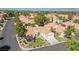 Aerial view of a house and neighborhood with lush landscaping and a golf course in the background at 7436 Silent Sage Dr, Las Vegas, NV 89149