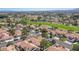 Aerial view of neighborhood near golf course and mountain range at 7436 Silent Sage Dr, Las Vegas, NV 89149