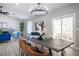 Bright dining area with sliding door to patio, chandelier and large table at 7436 Silent Sage Dr, Las Vegas, NV 89149