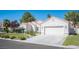 Single-story house with white stucco exterior, landscaped lawn, and two-car garage at 7436 Silent Sage Dr, Las Vegas, NV 89149