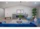 Living room with fireplace, blue chairs, and a large window at 7436 Silent Sage Dr, Las Vegas, NV 89149