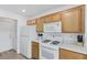 Kitchen with white appliances and oak cabinets at 8001 Delightful Ave, Las Vegas, NV 89128