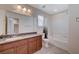 Bathroom with tub shower combination and wood cabinets at 8284 Southern Cross Ave, Las Vegas, NV 89131