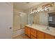 Bathroom boasts double vanity, stained glass window, and shower/tub at 9512 Canyonland Ct, Las Vegas, NV 89147