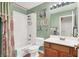 Relaxing bathroom with a shower/tub combo, wood vanity, and decorative accents at 10508 American Falls Ln, Las Vegas, NV 89144