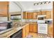 Kitchen features granite countertops, wood cabinets, and stainless steel appliances at 10508 American Falls Ln, Las Vegas, NV 89144