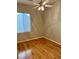 Bright bedroom with hardwood floors and a ceiling fan at 10809 Sleepy River Ave, Las Vegas, NV 89144