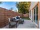 Relaxing patio with seating area, artificial turf, and brick wall at 10852 Avenzano St, Las Vegas, NV 89141