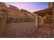 Landscaped backyard with brick patio and retaining wall at 12521 Lylan Ridge St, Las Vegas, NV 89138