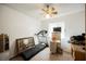 Bedroom with ceiling fan, treadmill, and wood desk at 2404 Camelia Cir, Las Vegas, NV 89108