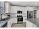 Modern kitchen with white cabinets, gray countertops, and stainless steel appliances at 367 Cadence Vista Dr, Henderson, NV 89011