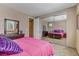 Spacious bedroom with mirrored closet doors and a pink comforter at 3906 Jacob Lake Cir, Las Vegas, NV 89118