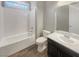 Clean bathroom with a tub, toilet and dark vanity at 480 Sterling Falls Ave, Henderson, NV 89011