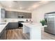 Modern kitchen with gray cabinets, island, and stainless steel appliances at 629 Soaring Wings Ave, Las Vegas, NV 89183