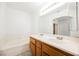 Bathroom with wood cabinets, double sinks, and bathtub at 6501 Old Oxford Ave, Las Vegas, NV 89108