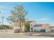 Two-story house with a tile roof, attached garage, and a tree in the front yard at 6501 Old Oxford Ave, Las Vegas, NV 89108