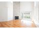 Living room with hardwood floors, fireplace, and sliding glass doors to backyard at 6501 Old Oxford Ave, Las Vegas, NV 89108