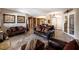 Elegant living room with leather sofas and stone fireplace at 7561 Prancing Pony Ct, Las Vegas, NV 89131