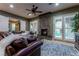 Relaxing living room features a stone fireplace and French doors to backyard at 8223 Windrush Ave, Las Vegas, NV 89117